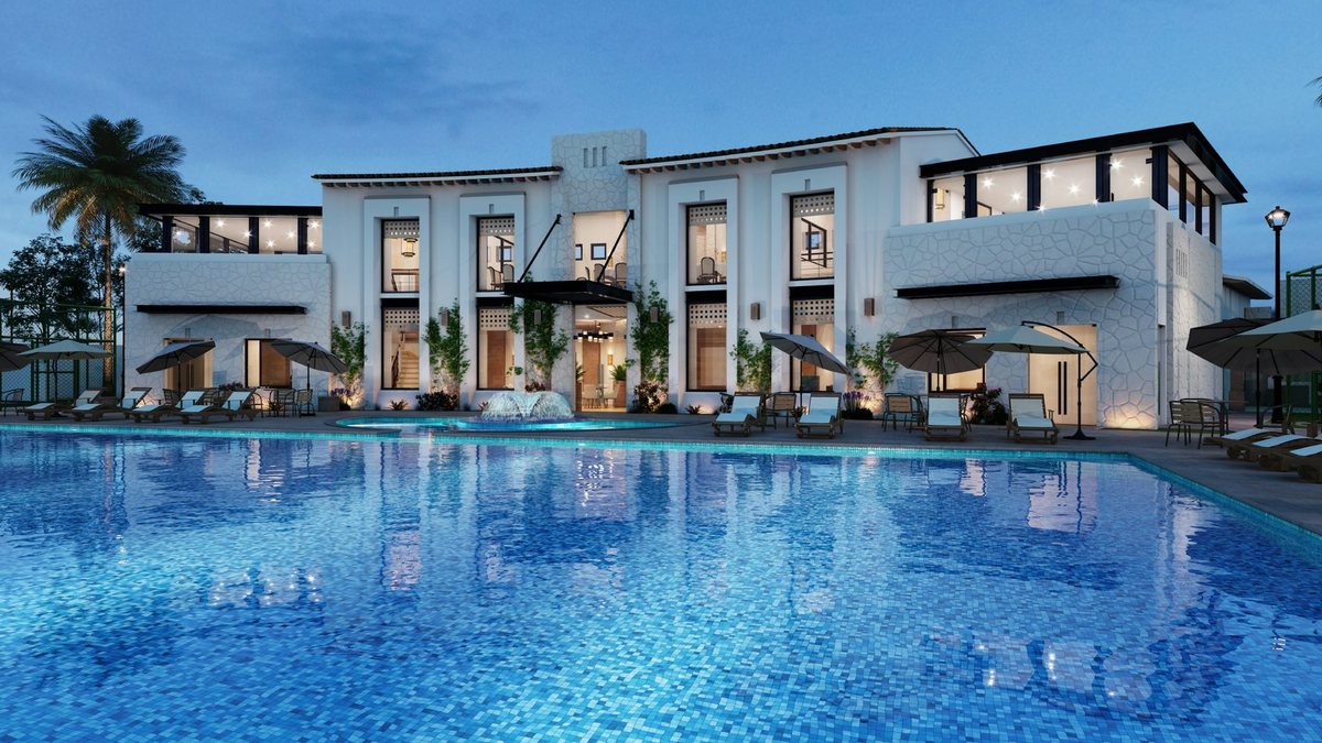 Resort hotel with a large pool illuminated at dusk